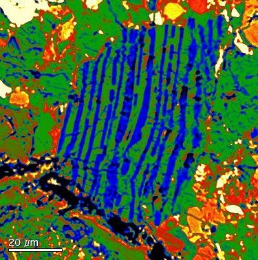 Granophyric clast composed of ribbon-like intergrowth of silica (blue) and K-feldspar (green).