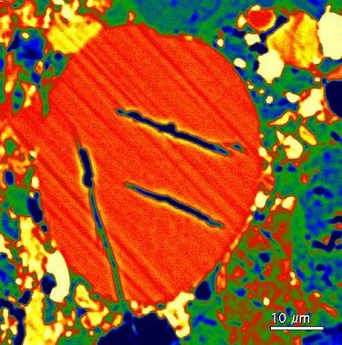 Small glass sphere, probably impact melt droplet (diagonal line are polishing scratches).