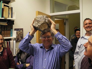 Dr. Don Brownlee of NASA Stardust Mission fame holding Northwest Africa 5000 in triumph over his head.