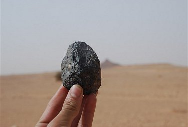 179.2 gram NWA 5406 individual with Siksou Mountain in background.